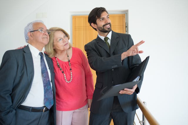 a-person-showing-a-property-to-an-elderly-couple