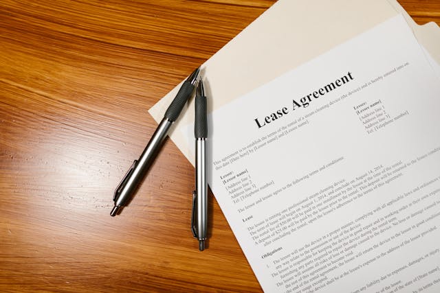 lease-agreement-on-wooden-surface-with-folder-and-pens