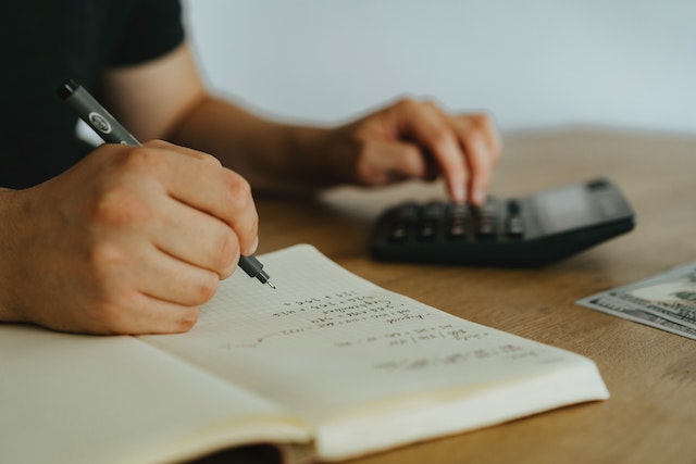 person-using-a-calculator-to-balance-a-budget